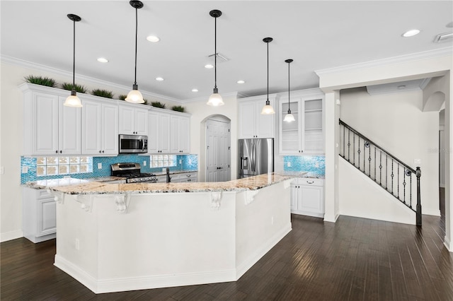 kitchen with white cabinetry, a large island, and stainless steel appliances