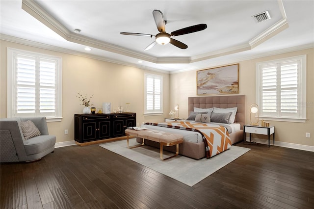 bedroom featuring dark wood-type flooring and a raised ceiling