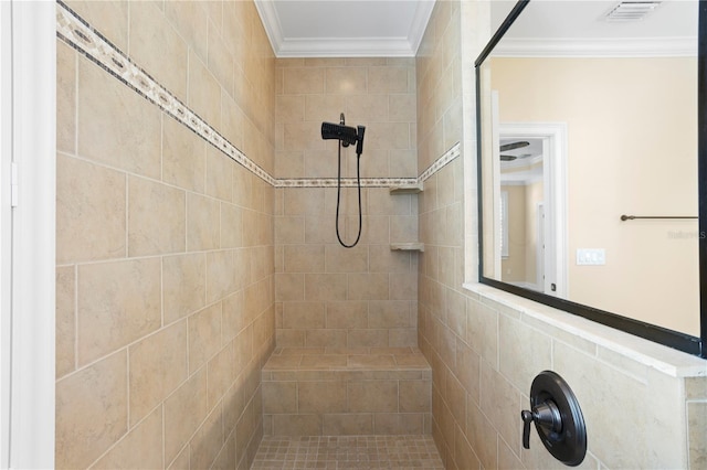 bathroom with crown molding and tiled shower