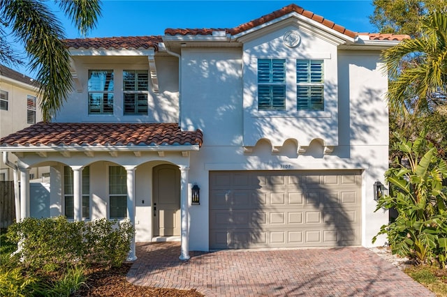 mediterranean / spanish home featuring a garage