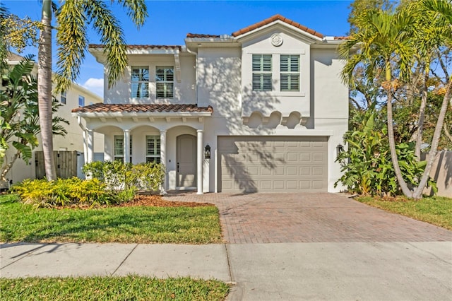 mediterranean / spanish-style house with a garage and a front yard