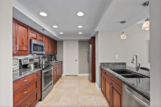 kitchen featuring stainless steel appliances, sink, decorative light fixtures, and dark stone counters