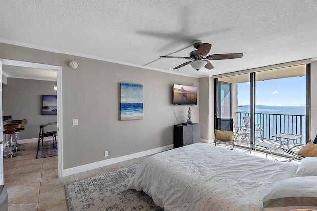 tiled bedroom with a textured ceiling, ornamental molding, expansive windows, ceiling fan, and access to exterior