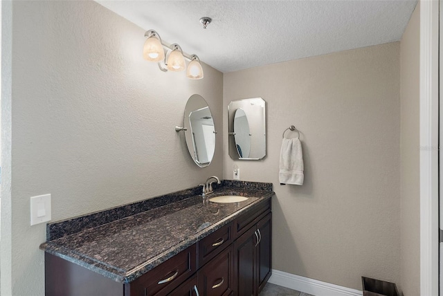 bathroom with vanity and a textured ceiling