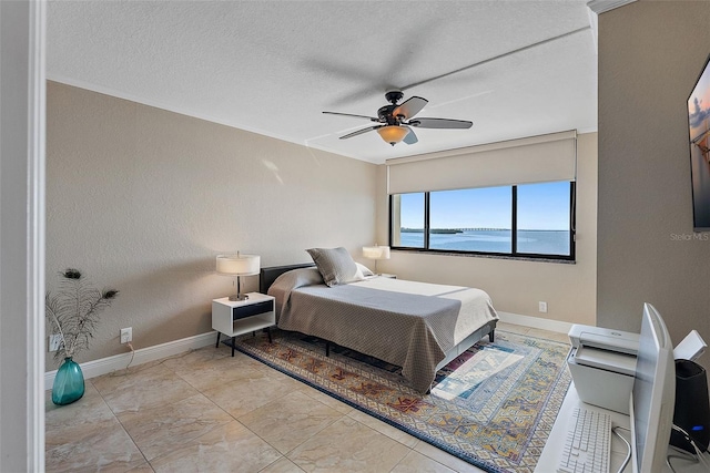 bedroom featuring a textured ceiling and ceiling fan