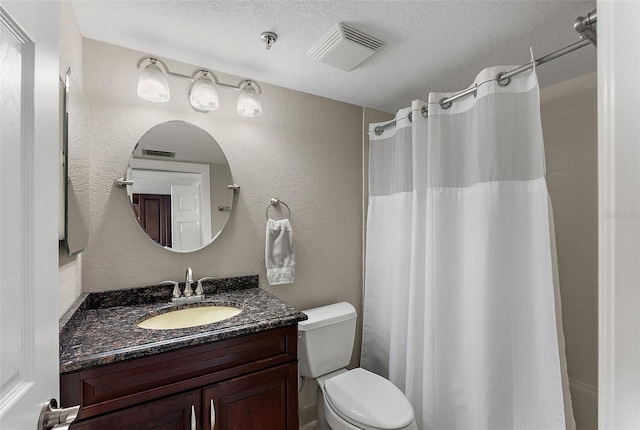 bathroom featuring vanity, a textured ceiling, curtained shower, and toilet