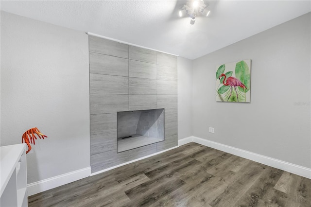 details with hardwood / wood-style flooring and a fireplace