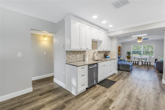 kitchen with white cabinetry, sink, backsplash, and dishwasher