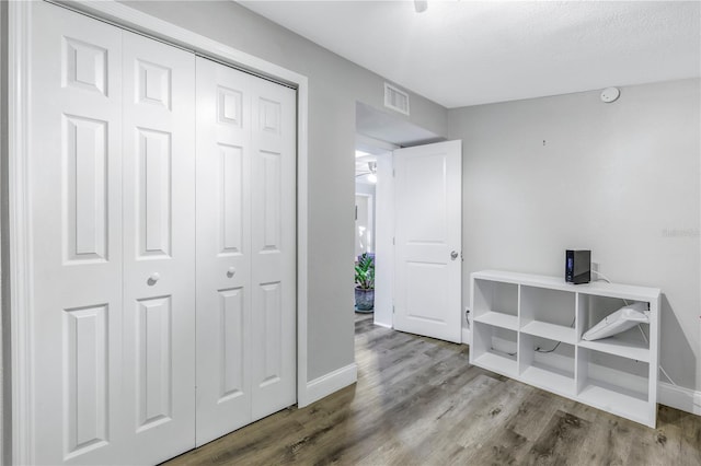 hallway featuring hardwood / wood-style flooring and a textured ceiling