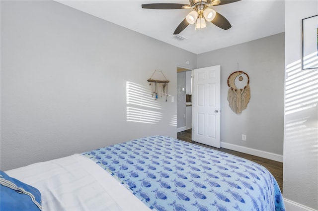 bedroom with ceiling fan and dark hardwood / wood-style flooring