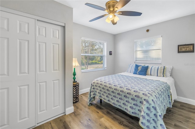 bedroom with hardwood / wood-style floors, a closet, and ceiling fan