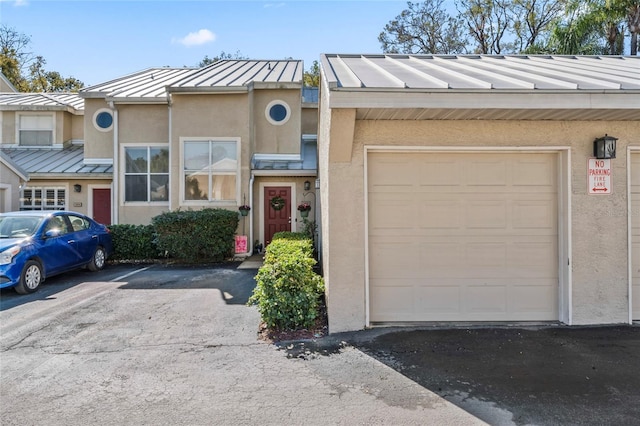 3406 Waterbridge Dr, Tampa, FL 33618 - multi unit property featuring stucco siding, a standing seam roof, an attached garage, and metal roof