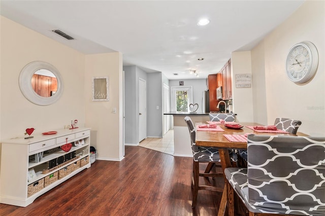 dining area with sink and light wood-type flooring