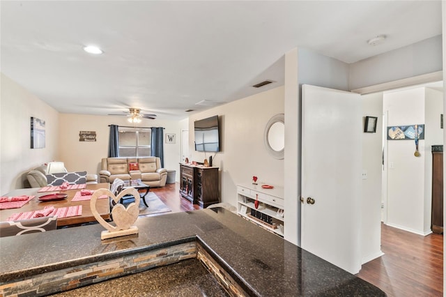 living room featuring hardwood / wood-style floors and ceiling fan