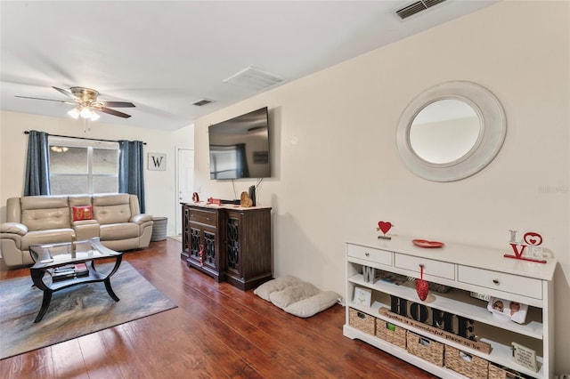 living room with ceiling fan and dark hardwood / wood-style flooring