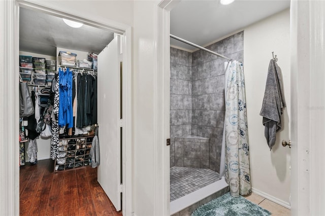 bathroom featuring hardwood / wood-style floors and a shower with shower curtain