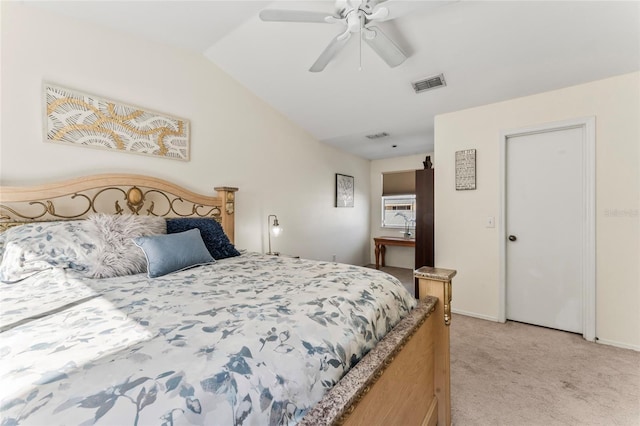 bedroom with ceiling fan, lofted ceiling, and light carpet