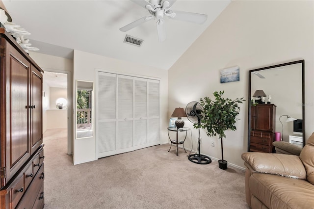 interior space with ceiling fan, high vaulted ceiling, and light carpet