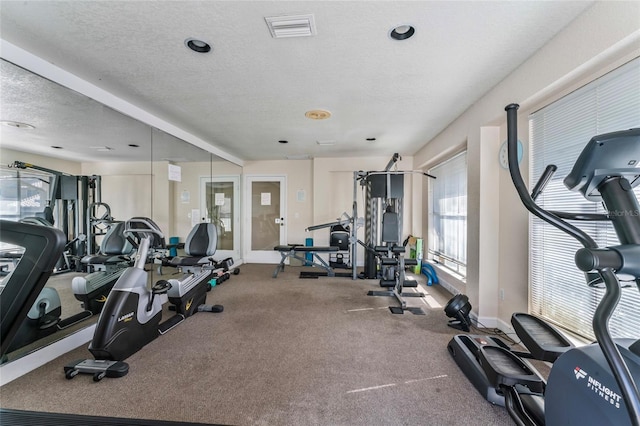 exercise room featuring a textured ceiling