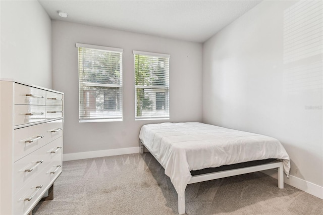 bedroom featuring light colored carpet