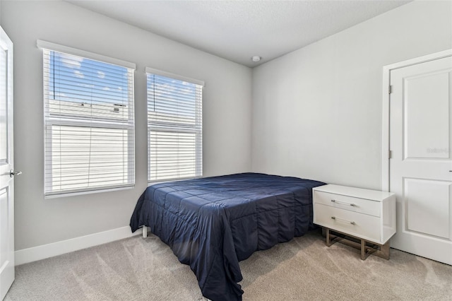 bedroom featuring light carpet