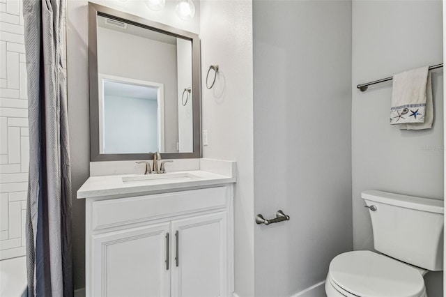 bathroom featuring vanity, toilet, and curtained shower