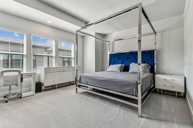 bedroom with carpet floors and a textured ceiling