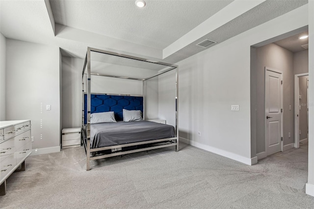 carpeted bedroom featuring a textured ceiling