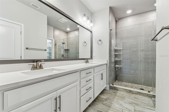 bathroom featuring vanity and an enclosed shower