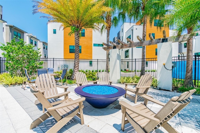 view of patio with a pergola and a fire pit