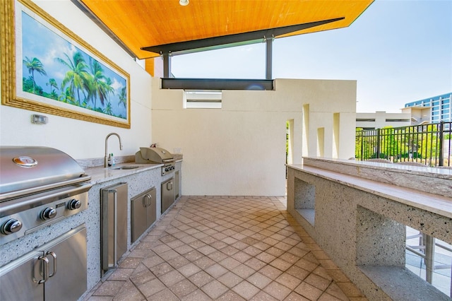 view of patio with area for grilling and sink