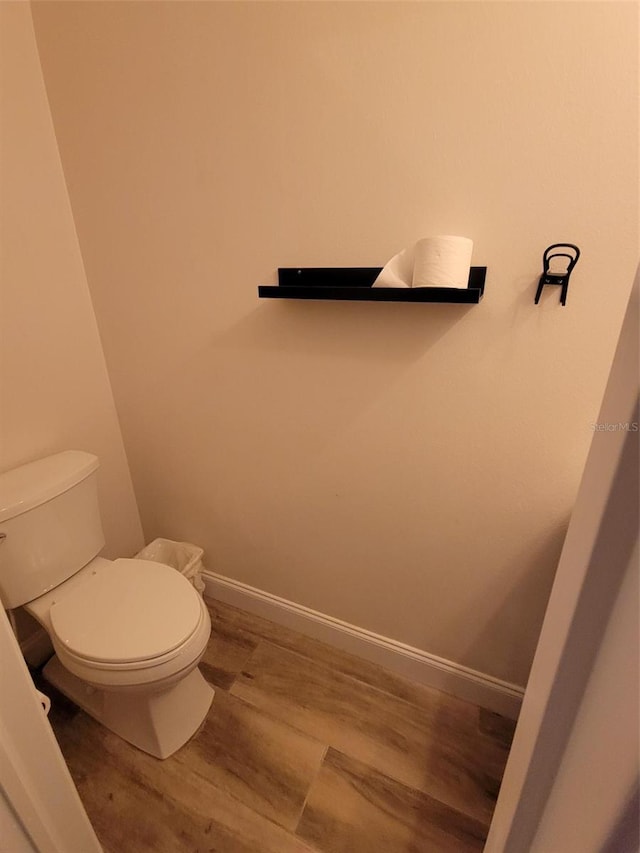 bathroom featuring hardwood / wood-style floors and toilet