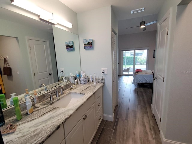 bathroom featuring ceiling fan, vanity, and hardwood / wood-style floors