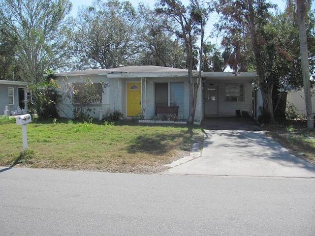 single story home with a front lawn and a carport