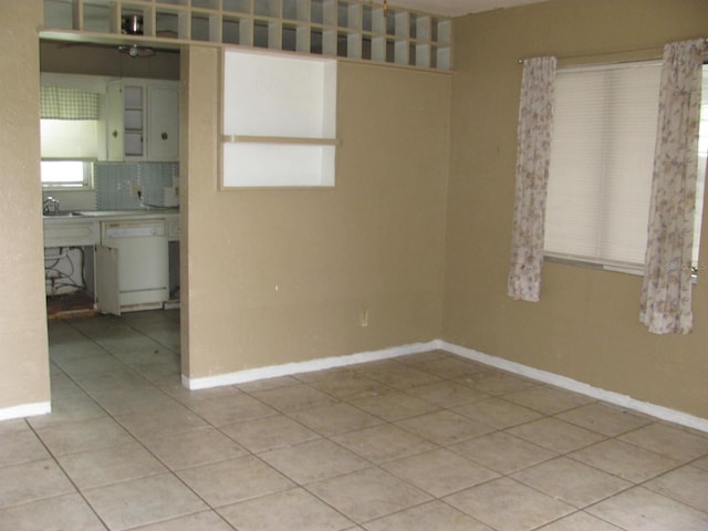 tiled spare room with sink