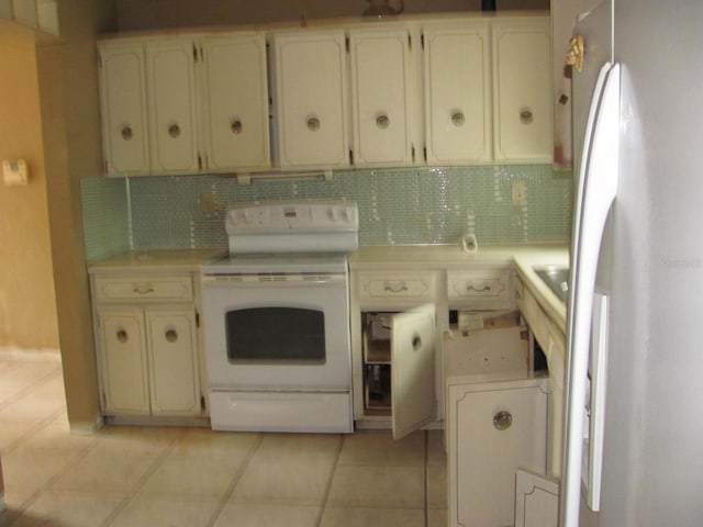 kitchen with tasteful backsplash, light tile patterned floors, and white appliances