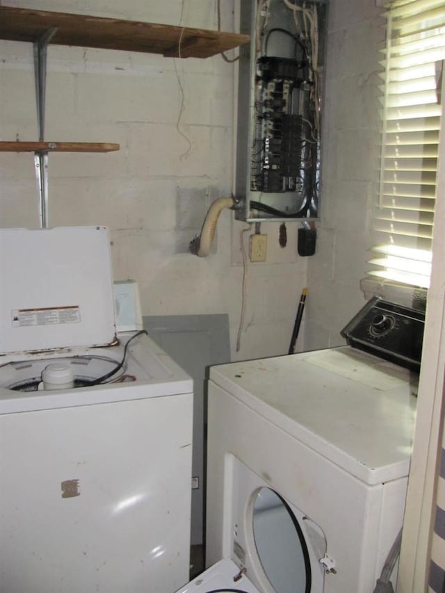 washroom featuring washing machine and clothes dryer and electric panel