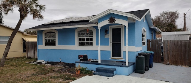 bungalow-style house featuring solar panels