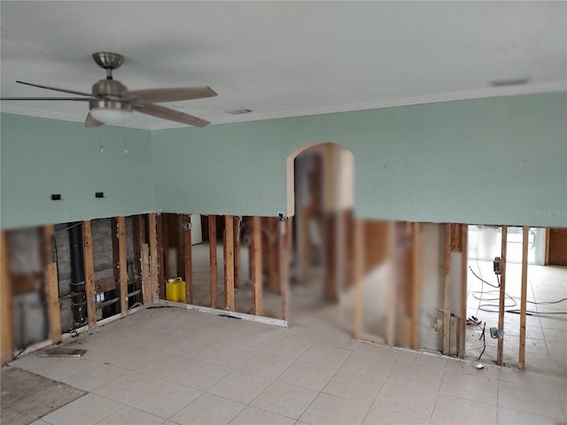 unfurnished room featuring ceiling fan, ornamental molding, and light tile patterned floors