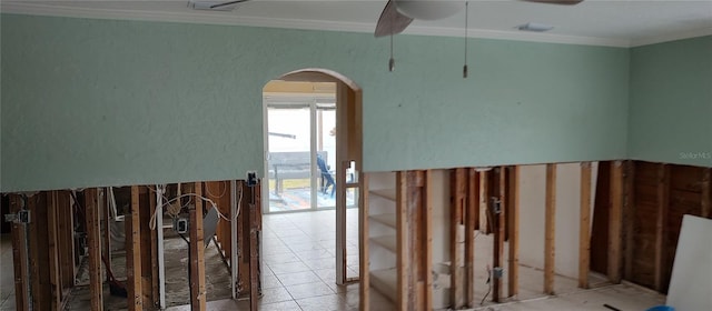 hallway featuring crown molding and light tile patterned floors