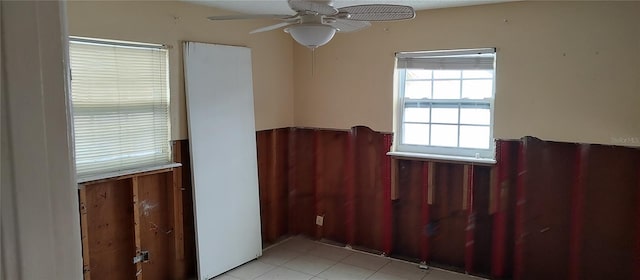 spare room with light tile patterned floors and ceiling fan