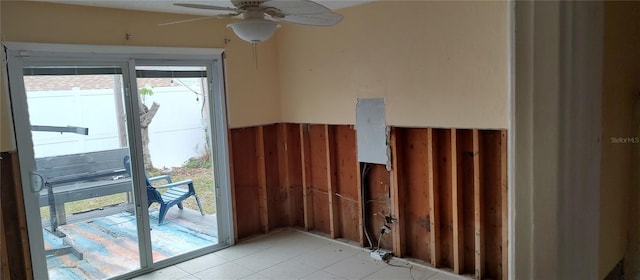 doorway to outside with light tile patterned flooring and ceiling fan