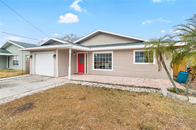 ranch-style home with driveway, an attached garage, and a front yard