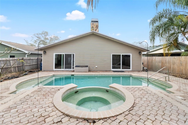 view of pool featuring an in ground hot tub