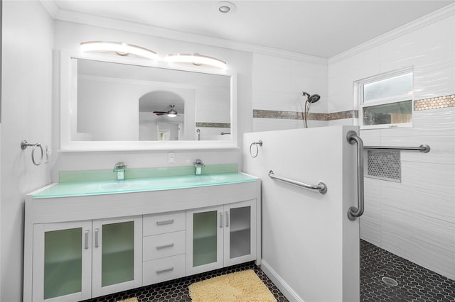 bathroom featuring ornamental molding, double vanity, a sink, and walk in shower