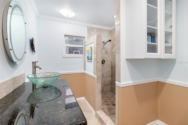 bathroom with ornamental molding, walk in shower, a sink, and tile patterned floors