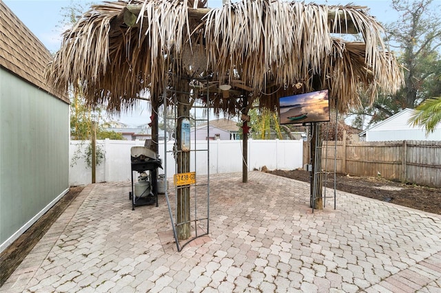 view of patio with a fenced backyard and area for grilling