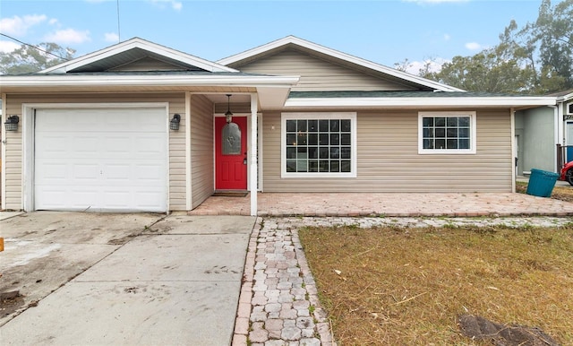 ranch-style house featuring driveway and an attached garage