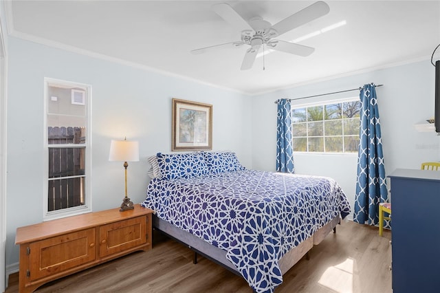 bedroom featuring ornamental molding, ceiling fan, and wood finished floors