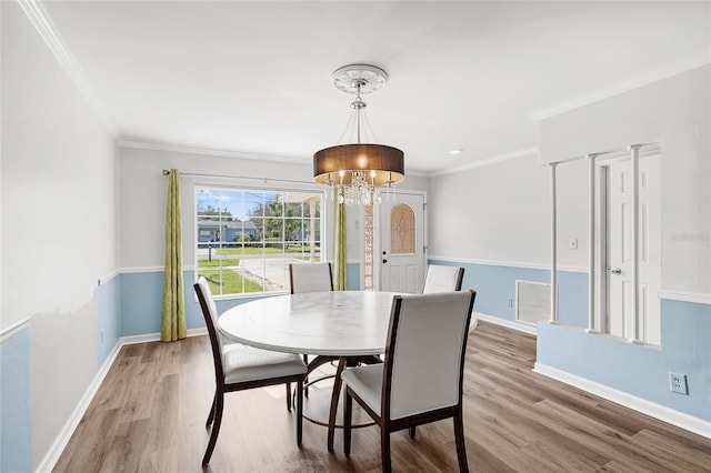 dining area featuring wood finished floors, visible vents, and baseboards